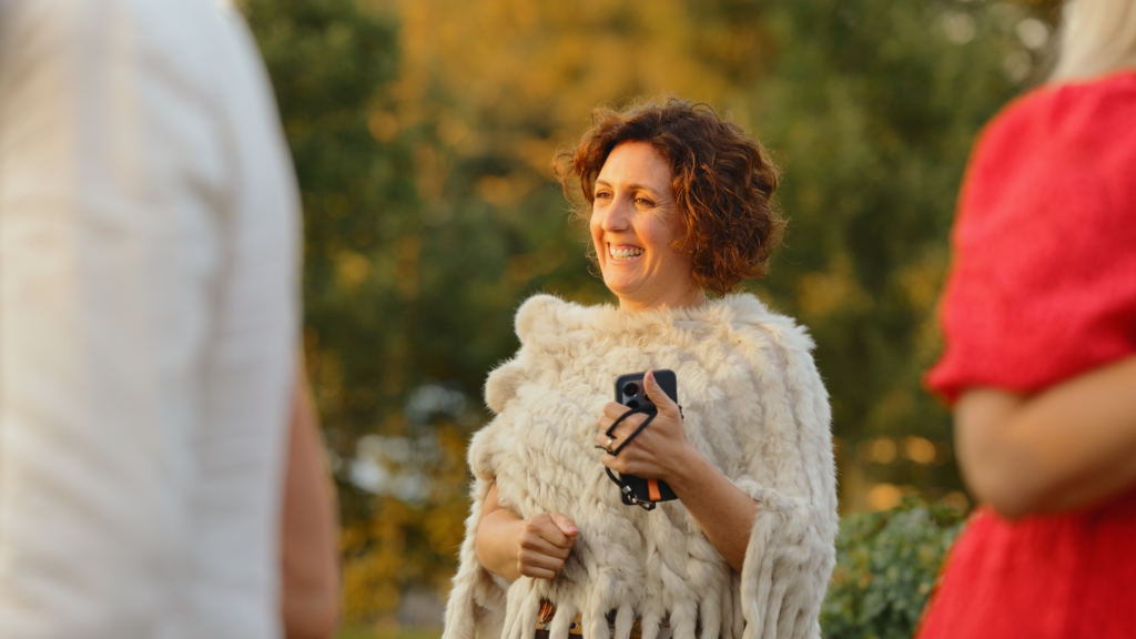 Guests dancing outside The Little Green Wedding Barn at golden hour captured by a Norfolk wedding videographer