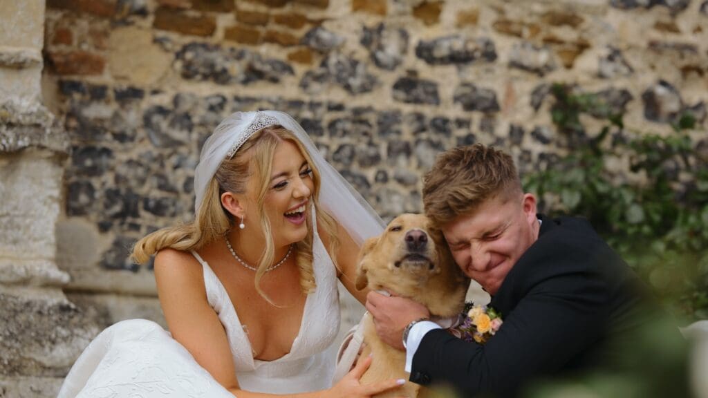 bride and groom with their dog on wedding day at pentney abbey