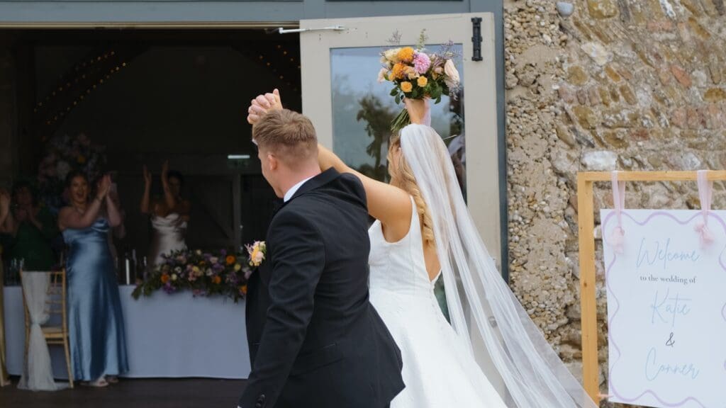 Bride and groom entrance into wedding breakfast at pentney abbey