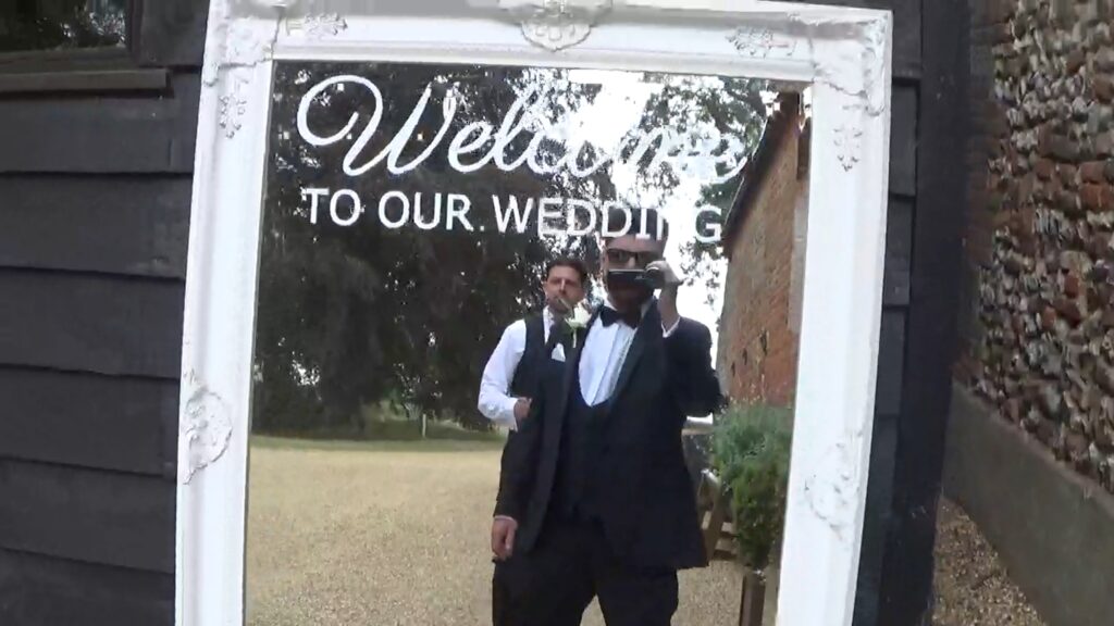 Groomsmen with camcorder at curds hall barn wedding