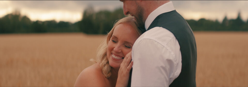 bride and groom in field at curds hall barn in norfolk
