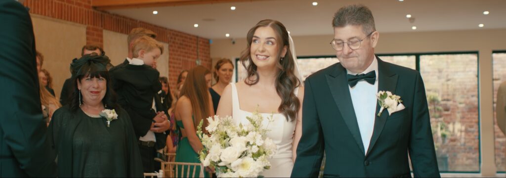 Bride sees groom down the aisle at Reymerston Hall Norfolk Wedding