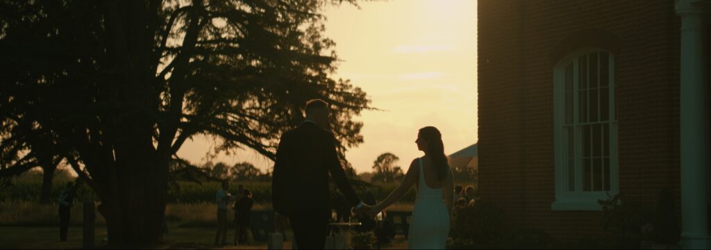 Bride and groom at golden hour outside Reymerston Hall Norfolk Wedding