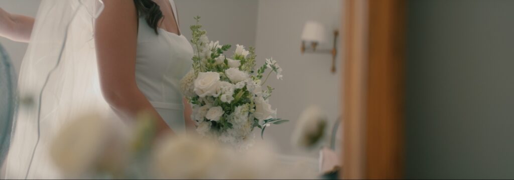 Bride getting into dress at Reymerston Hall Norfolk Wedding
