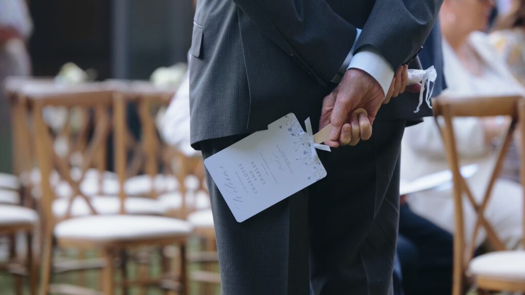 Father of the bride holding a Charlotte & Charlie card at the Hoste Arms in Norfolk