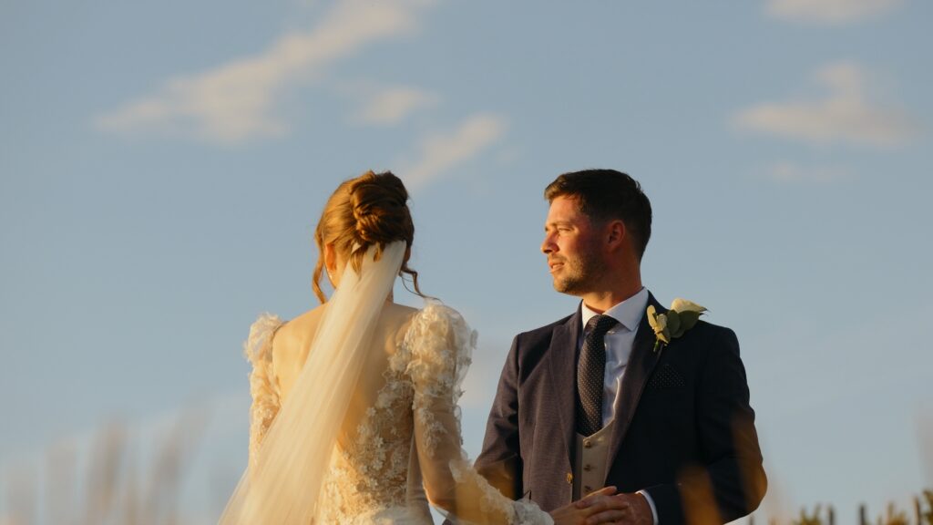Bride and groom at golden hour on Brancaster beach in Norfolk