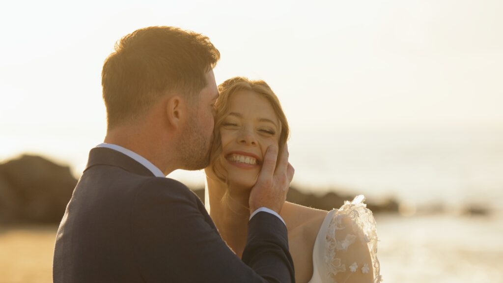 Bride and groom at golden hour on Brancaster beach in Norfolk