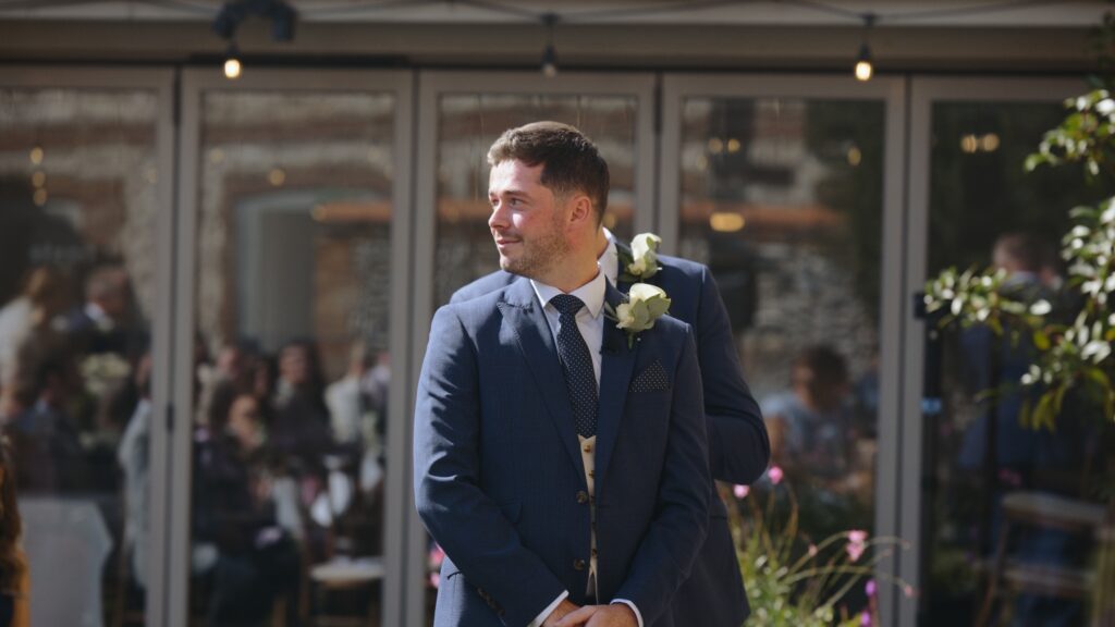 Groom reaction to bride walking down aisle at The Hoste Arms in Norfolk