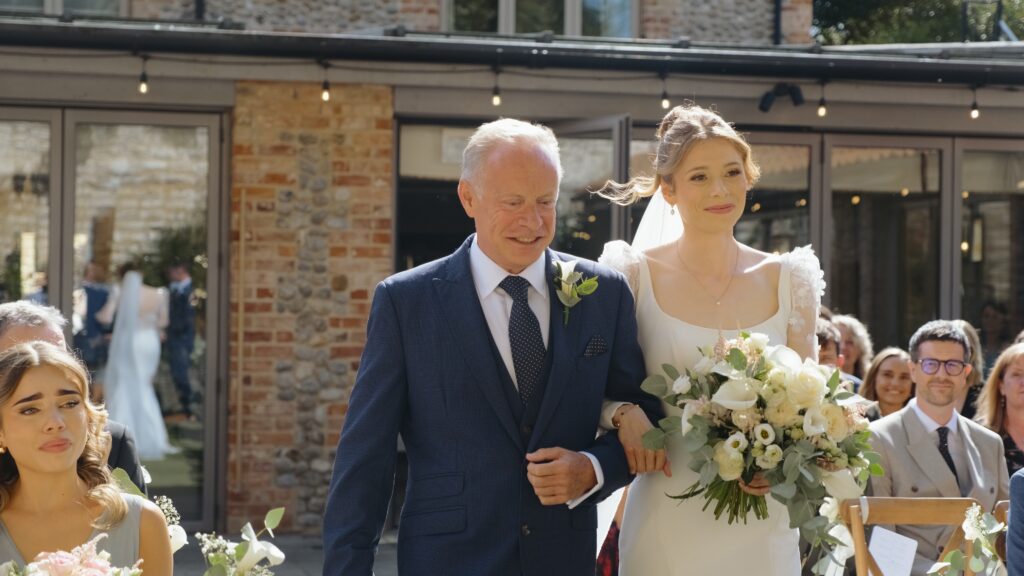 Bride walking down the aisle at wedding at The Hoste Arms in Norfolk