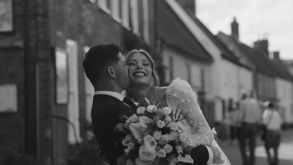 Bride and groom walking through burnham market in Norfolk on their wedding day